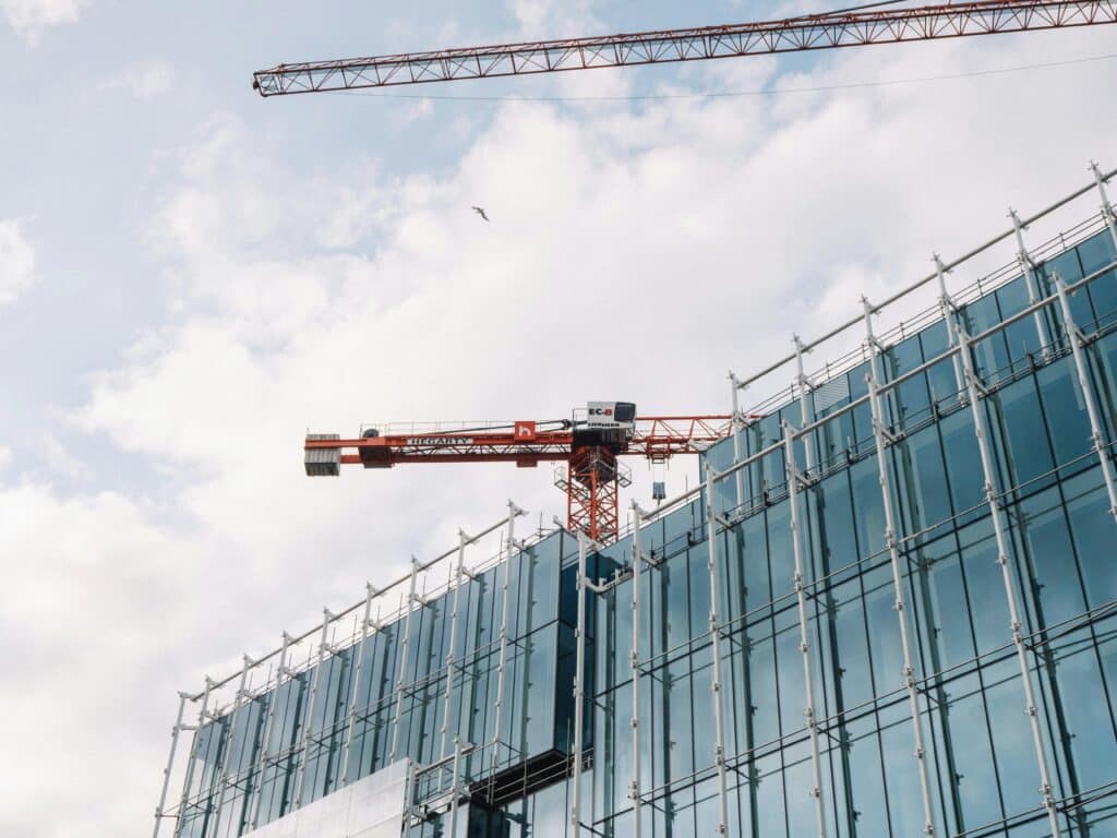 Modern Construction Site with Glass Facade and Crane