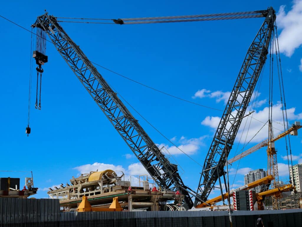 Heavy cranes operating at an industrial construction site