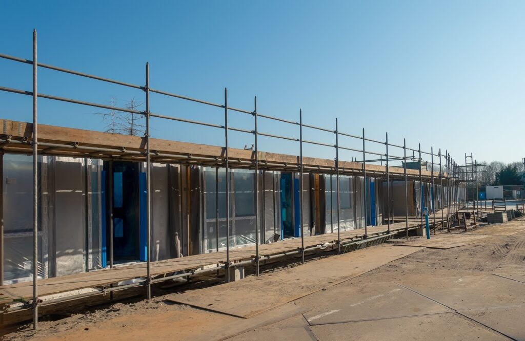 Commercial construction building with scaffolding, illustrating skilled trades and construction workforce development.